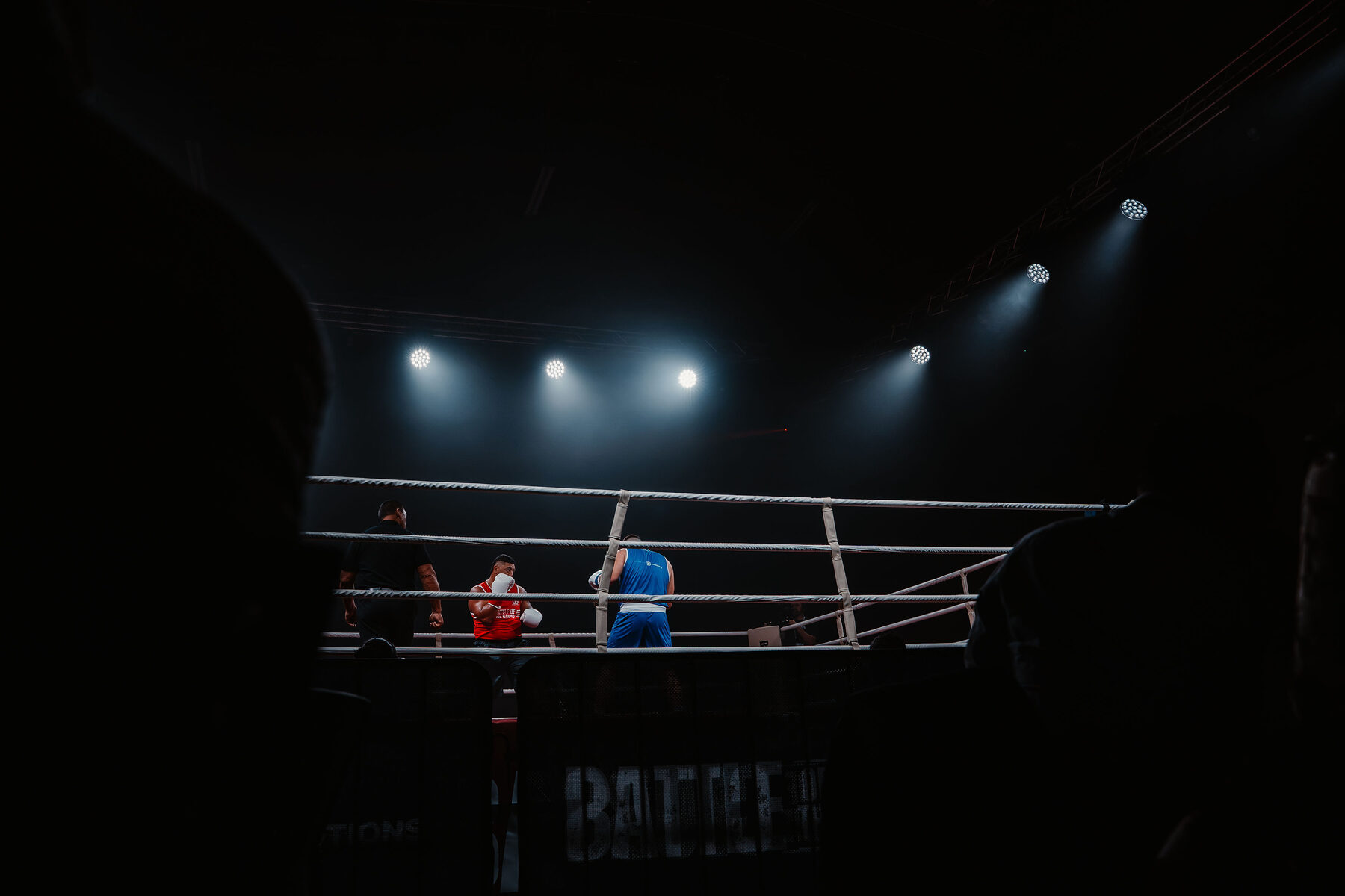 Two club fighters under the lights at McKay Stadium